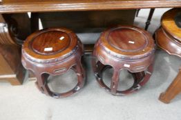 A pair of Chinese hardwood barrel shaped stands, 46.5cm