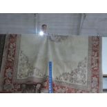 A large Chinese carpet having central floral spandrel