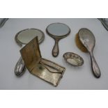 A silver backed brush and two silver backed hand mirror. Also with a small silver pierced trinket di