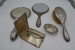A silver backed brush and two silver backed hand mirror. Also with a small silver pierced trinket di