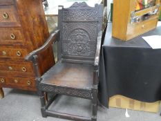 An antique Wainscot style chair probably from the period having carved back and frieze