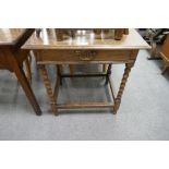 An antique oak side table having one long drawer on bobbin legs, 66.5cm