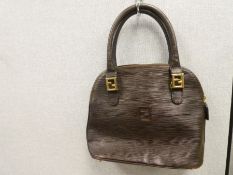 A vintage brown leather handbag, bought in the 1980s, with gold coloured interior marked 'Fendi' Nic