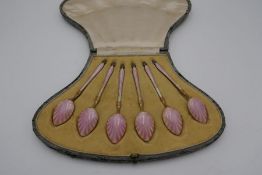 A beautiful set of silver gilt and pink guilloche enamel teaspoons with the enamel in sun ray design