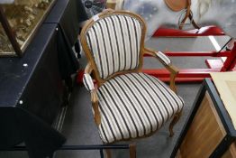 A pair of French Beech open armchairs having striped upholstery