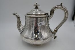 A larger Georgian silver teapot having ornate engraved decoration of foliate design. Decorative hing