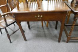 An antique oak side table having one long drawer on square and chamfered legs, 82cm