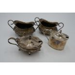 A pair of Walker and Hall silver salts having ornate, repoussed design. Also with other salts having