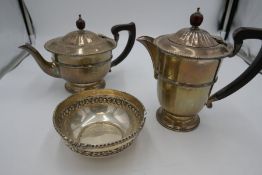 A silver tea and coffee pot of half reeded design, having reeded lid and border, on a raised pedesta