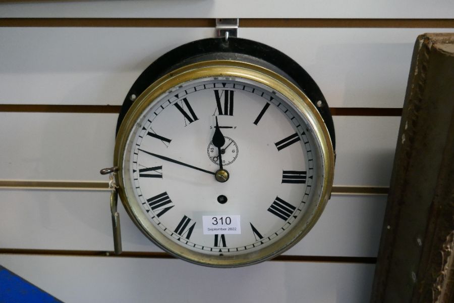 An old ships bulkhead clock having brass bezzle with black painted surround - Image 2 of 3