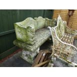 A reconstituted garden bench having raised back and sides on animal supports, 139cm