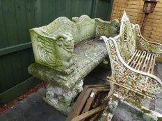 A reconstituted garden bench having raised back and sides on animal supports, 139cm