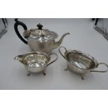 A silver teaset with scalloped design border and four feet. Hallmarked Birmingham 1931 Marson and Jo