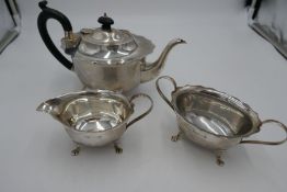 A silver teaset with scalloped design border and four feet. Hallmarked Birmingham 1931 Marson and Jo