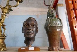 A metal bust on plinth depicting a male head, a vintage earthenware glazed jug