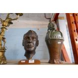 A metal bust on plinth depicting a male head, a vintage earthenware glazed jug