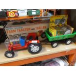 A boxed battery operated Farm Tractor with Trailer, and a small tractor