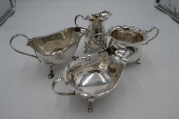 Silver items of similar design to include a milk jug and sugar bowl by William Henry Sparrow, Birmin