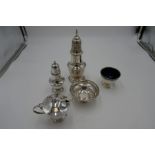 A silver lot comprising a silver Barker Ellis Silver Co sugar sifter, with a silver cruet set having