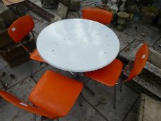 A treto circular table with a set of four chairs