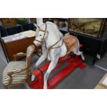 A Victorian style dappled grey rocking horse on red painted base, 175cm approx