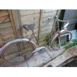A vintage ladies bicycle by Automoto with a leather saddle