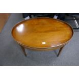 A reproduction mahogany oval coffee table on square legs, 92cm