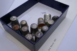 A quantity of silver and metal thimbles with various ornate, embossed design, and hallmarks to inclu