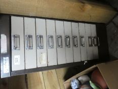 A metal filing cabinet having 10 drawers
