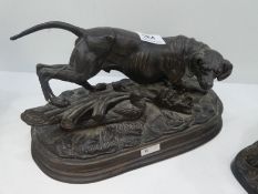 A reproduction bronze figure of dog on oval base and one other cast iron dog sculpture