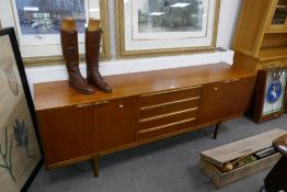 A McKintosh 1970's teak sideboard, having 4 central drawers flanked by cupboards, 213cm