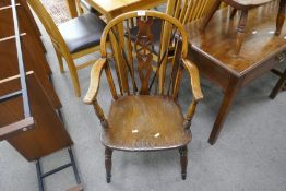An antique oak Windsor Wheelback chair and one other smaller stickback chair