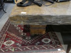 A large oblong coffee table having thick Walnut too, roughly cut on 2 square pedestal supports
