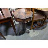 An old mahogany sewing table having octagonal top and rising lid