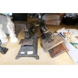 A vintage hand crank sewing machine by "Wilcox & Gibbs Sewing company" and another
