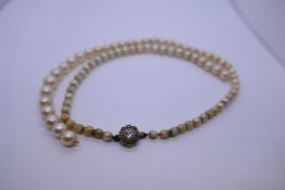 Antique string of pearls with yellow gold clasp in the form of a flower head inset diamonds, pearls,