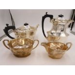 A silver tea service comprising of an octagonal teapot, coffee pot, two handled sugar bowl and cream