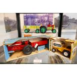 Two vintage ERTL tractors to include an international Cub Cadet and a tin plate clockwork tractor an