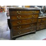 An antique mahogany chest having 5 long graduated drawers