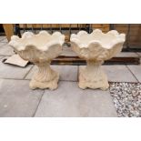 A pair of garden urns decorated leaves
