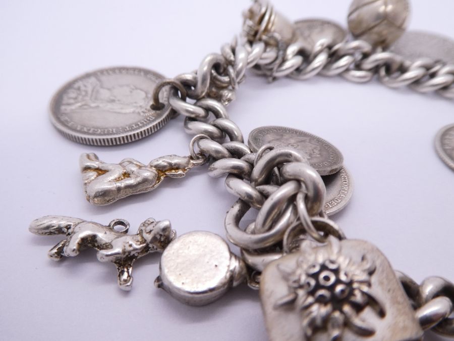 Silver charm bracelet hung with antique and later coins, charms etc including Fireman's helmet, ball - Bild 3 aus 5