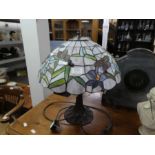 A Tiffany style table lamp decorated butterflies