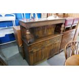 A reproduction Oak Court cupboard, having carved decoration