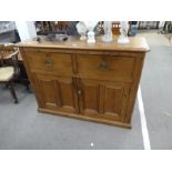 An old pine kitchen cupboard having panelled doors with drawers above, 130cm