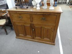 An old pine kitchen cupboard having panelled doors with drawers above, 130cm