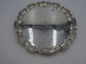 A larger Walker and Hall silver salver with scroll feet and raised border. Hallmarked Sheffield 1934