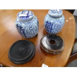 A pair of Chinese blue and white ginger jars, with wooden stands