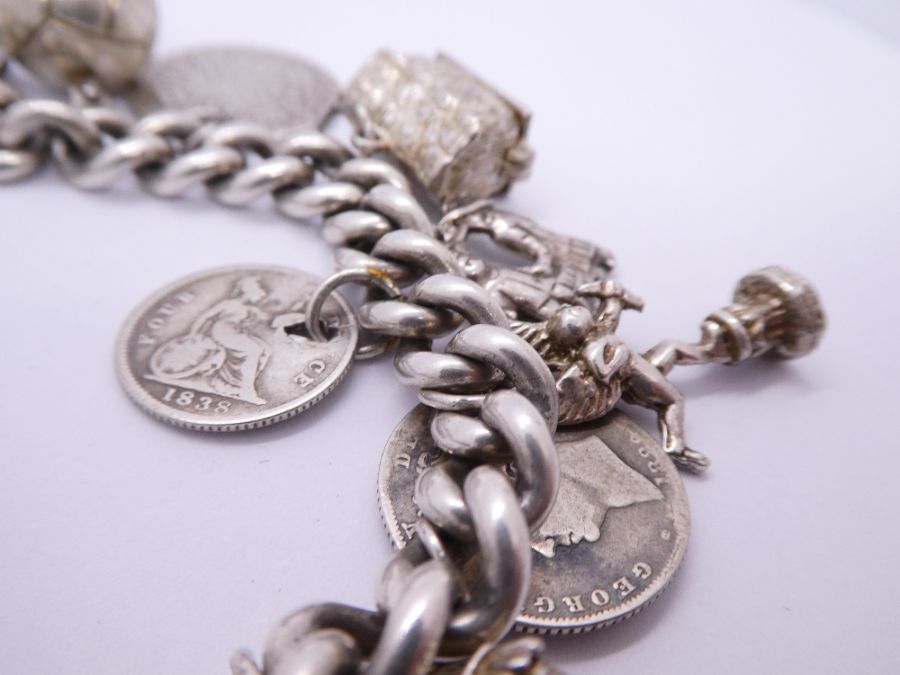 Silver charm bracelet hung with antique and later coins, charms etc including Fireman's helmet, ball - Bild 4 aus 5