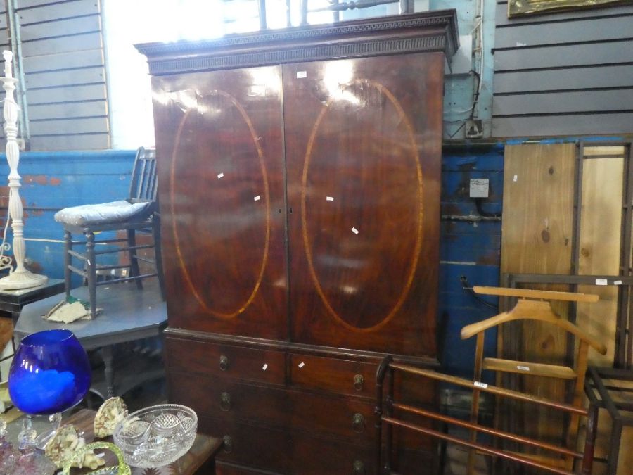 An antique mahogany wardrobe converted from a linen press