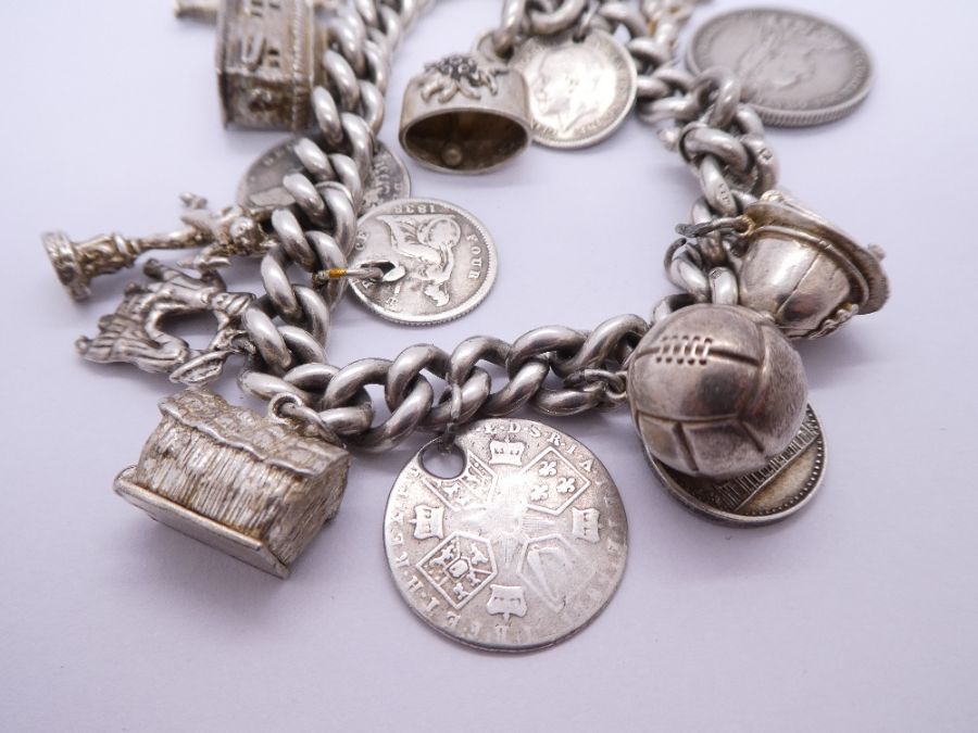 Silver charm bracelet hung with antique and later coins, charms etc including Fireman's helmet, ball - Bild 5 aus 5